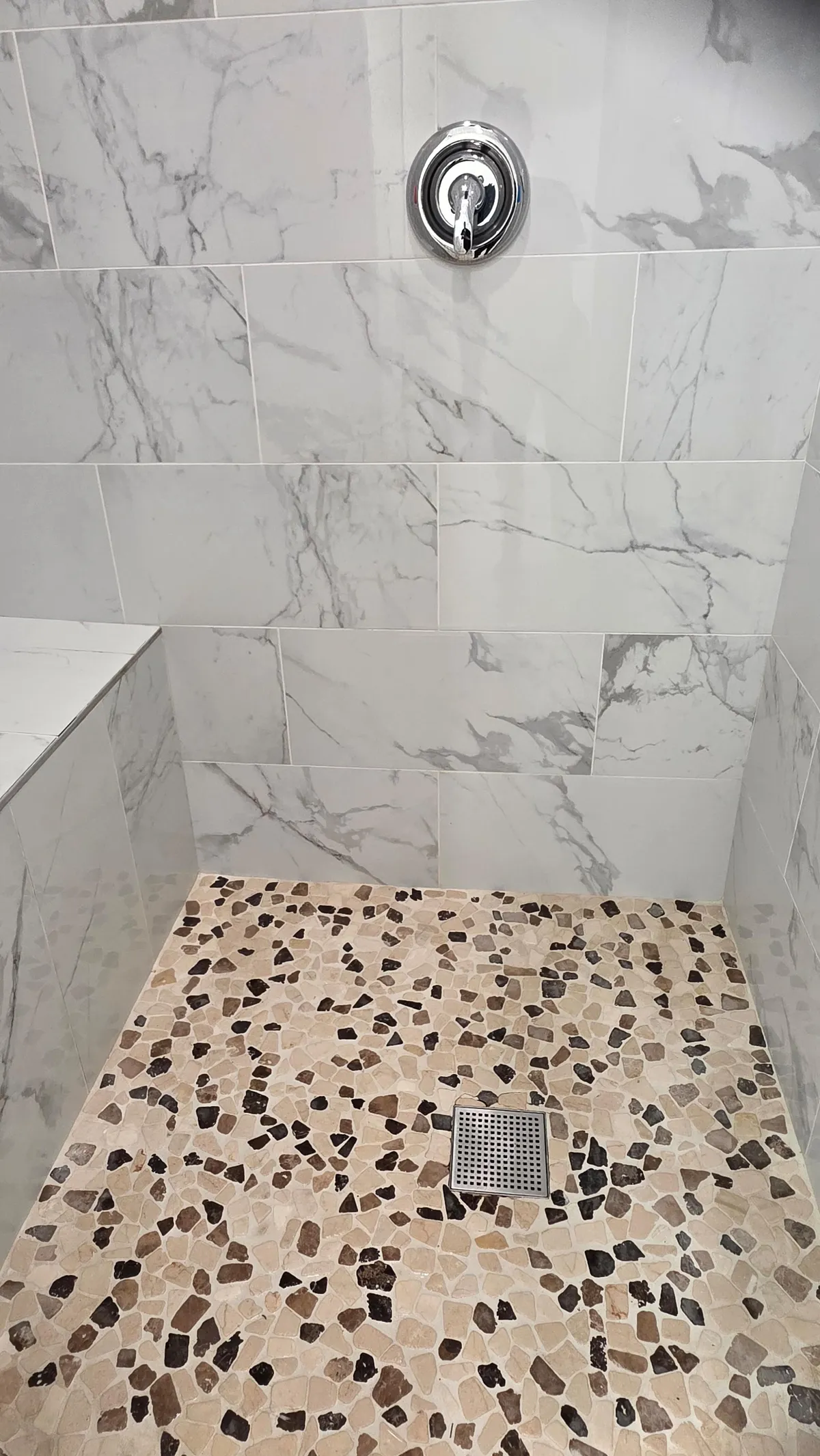 Spotless marble walk-in shower after deep cleaning
