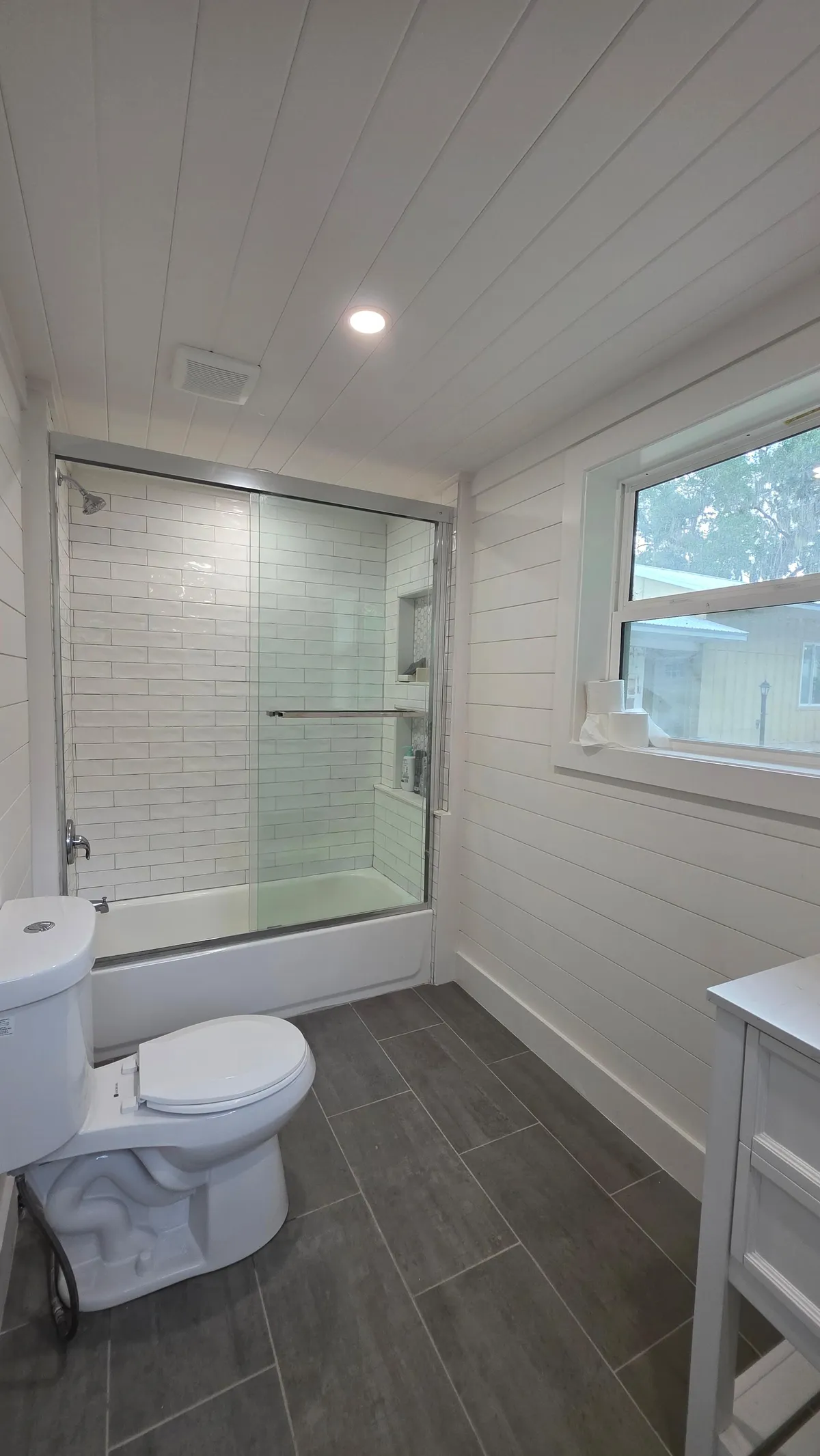 Shiplap bathroom with glass shower after cleaning in Ocala