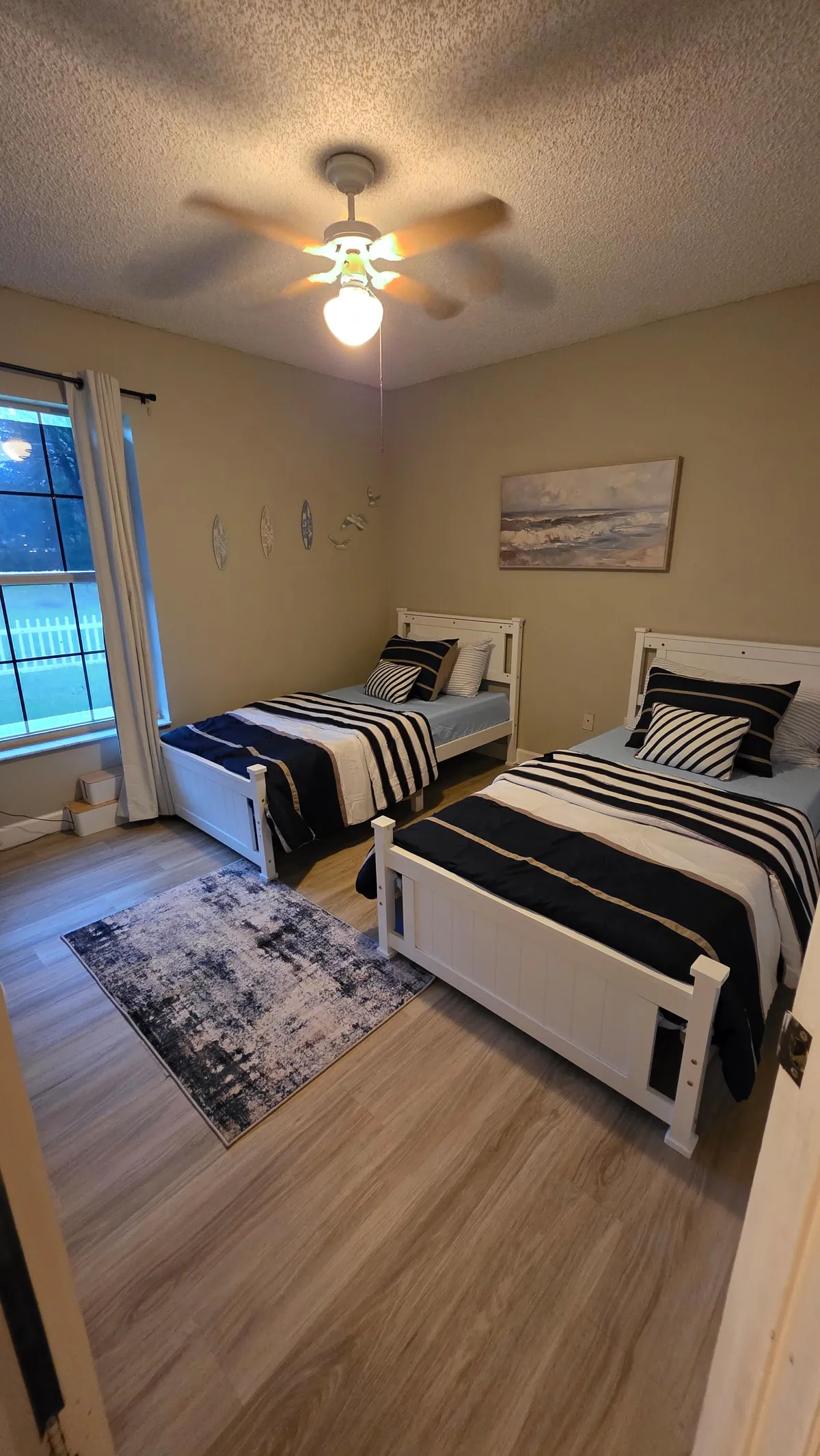 Twin guest bedroom with crisp bedding after cleaning